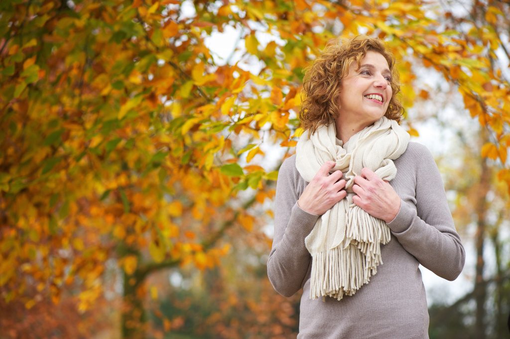 Older Woman Smiling in Autumn